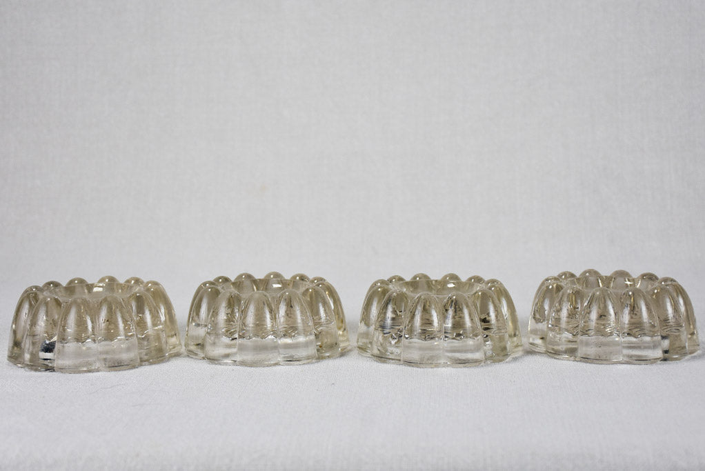 Set of four vintage French glass table risers