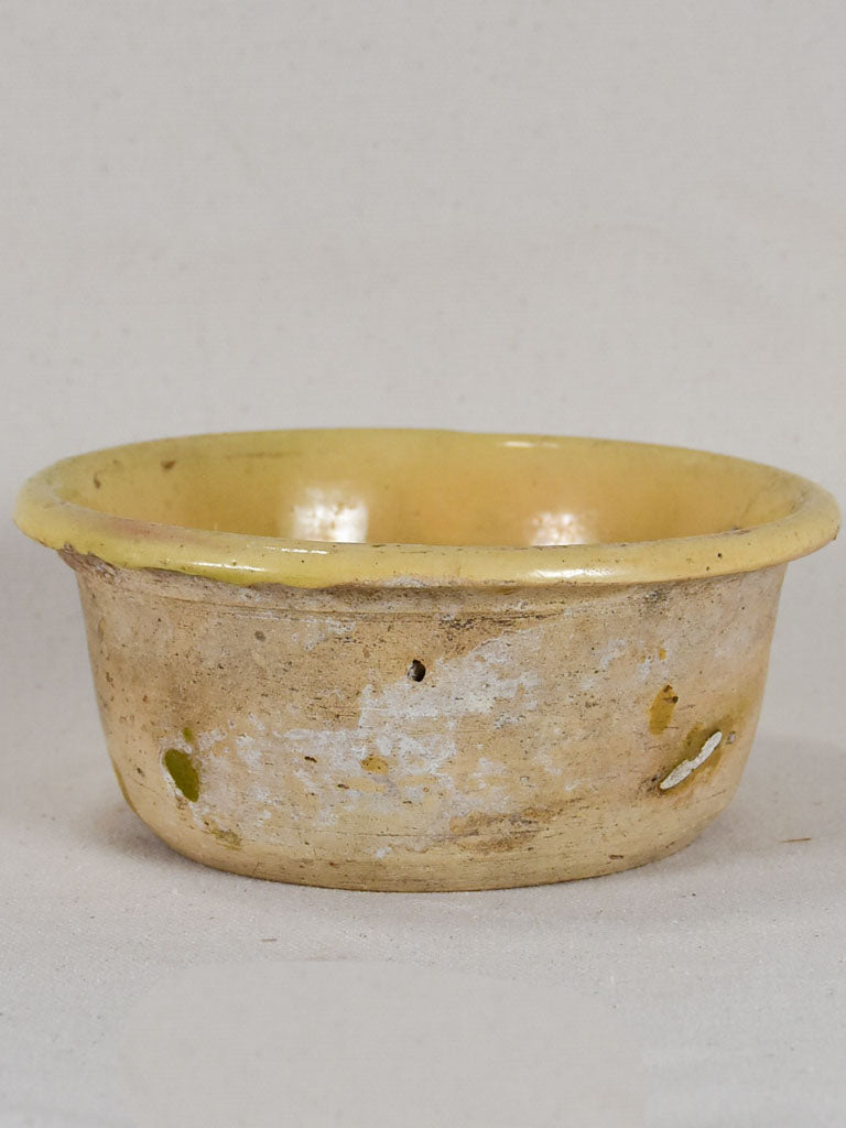 Antique French teracotta cheese strainer with yellow glaze