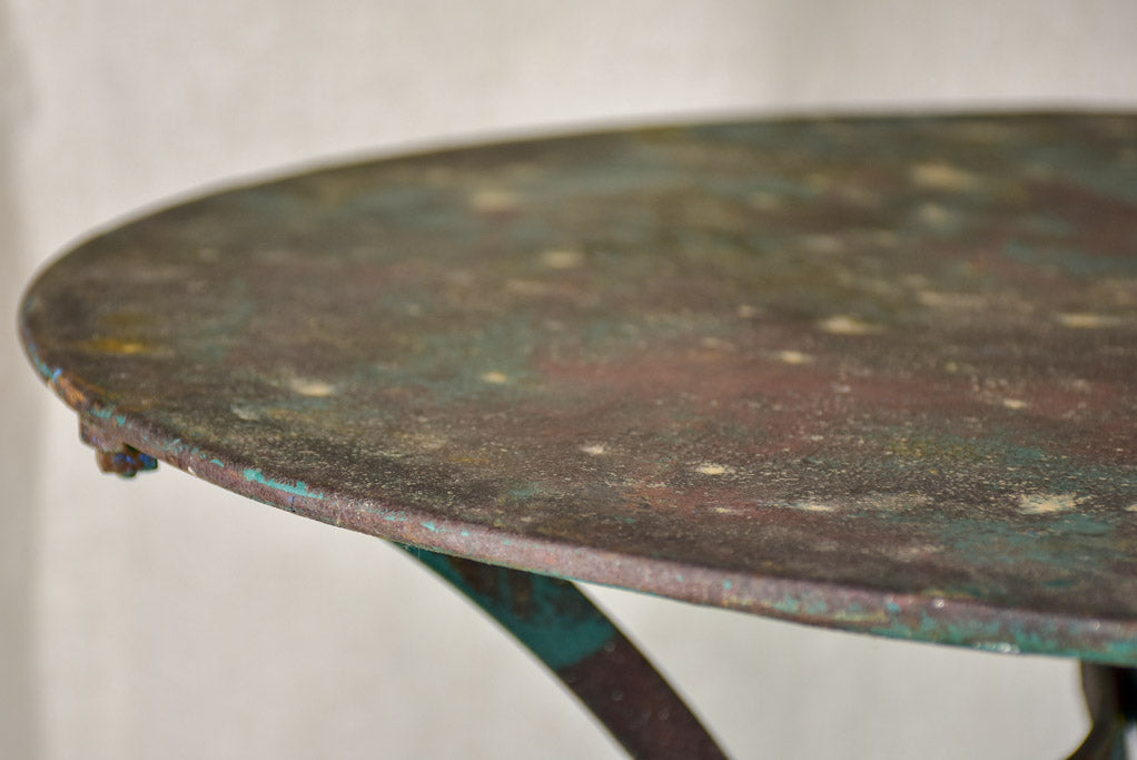 Round antique French garden table with green patina