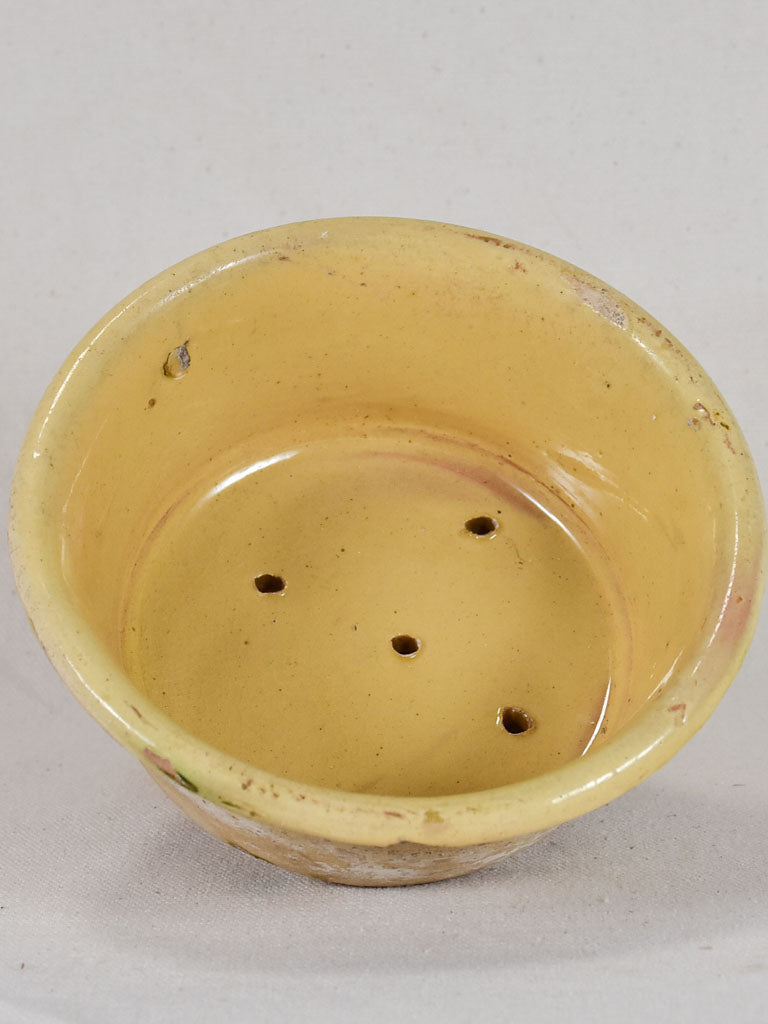 Antique French teracotta cheese strainer with yellow glaze