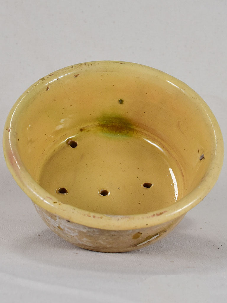 Antique French teracotta cheese strainer with yellow glaze