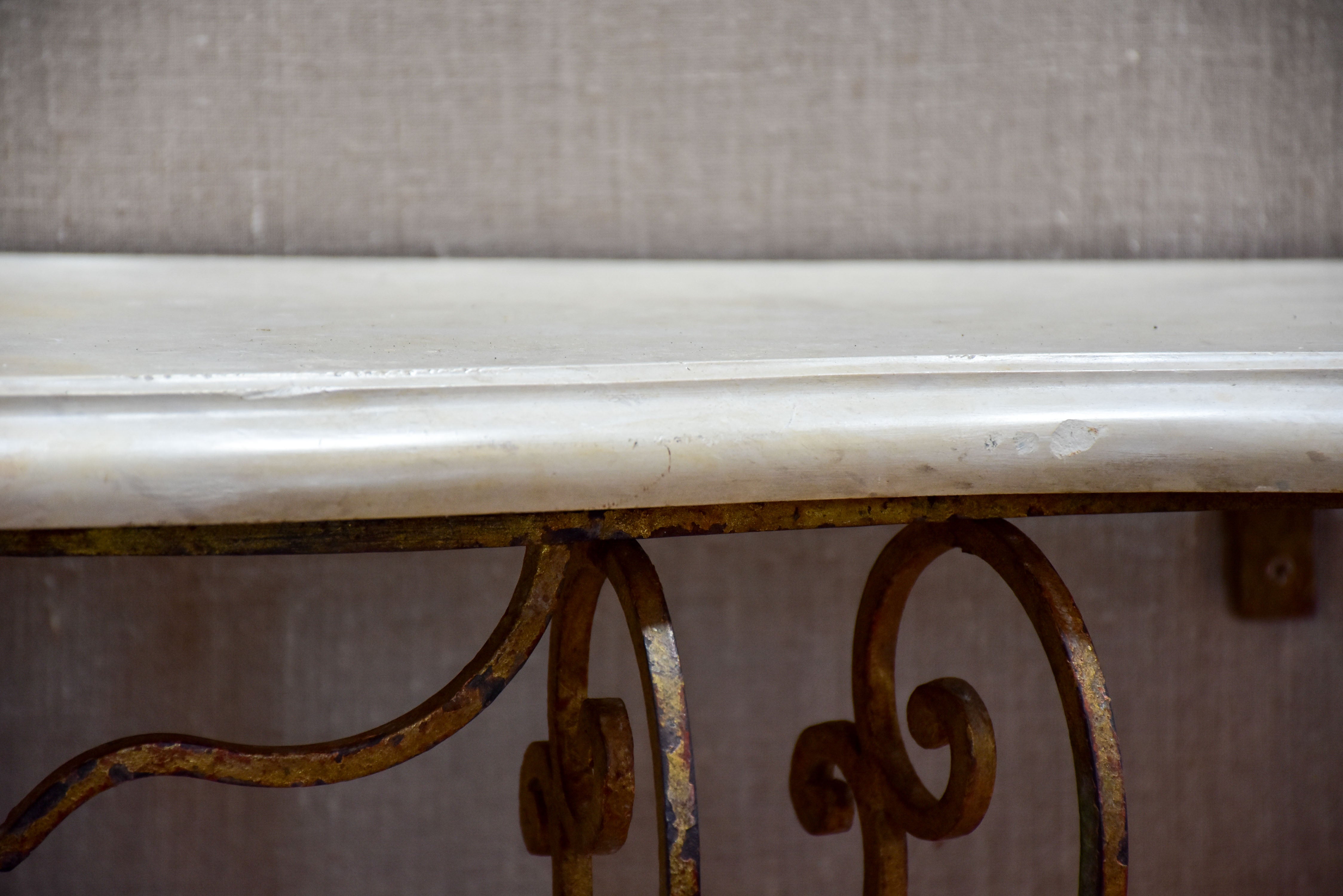 Floating console table with cream marble top and decorative iron base