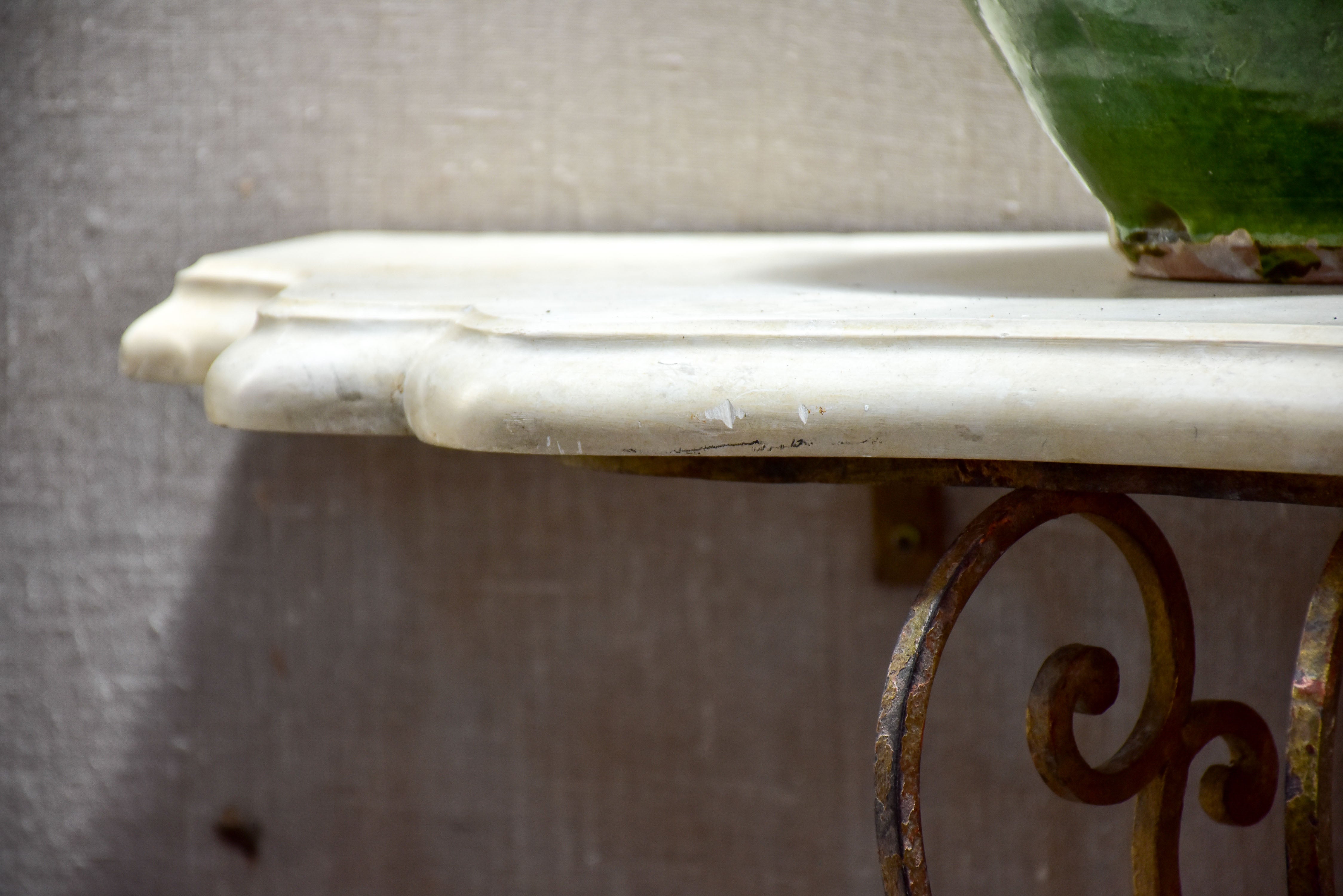 Floating console table with cream marble top and decorative iron base