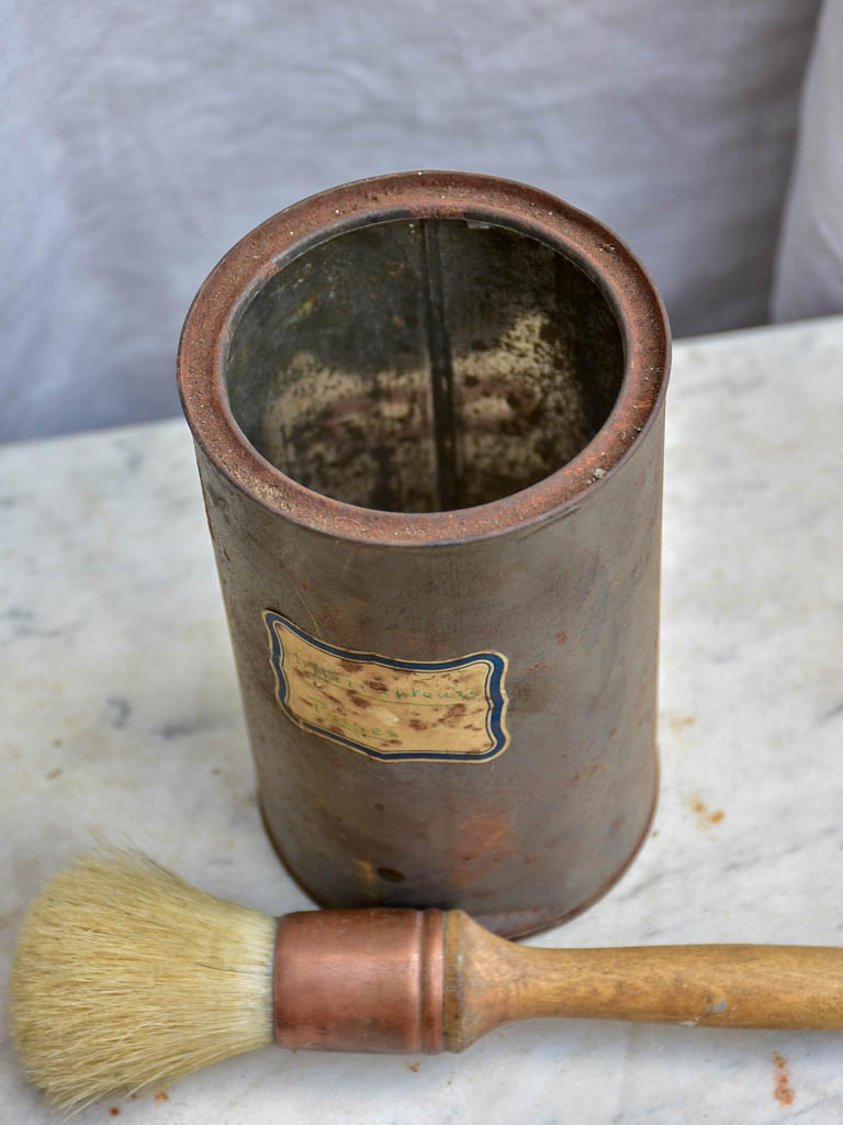 Collection of vintage paint brushes in a tin