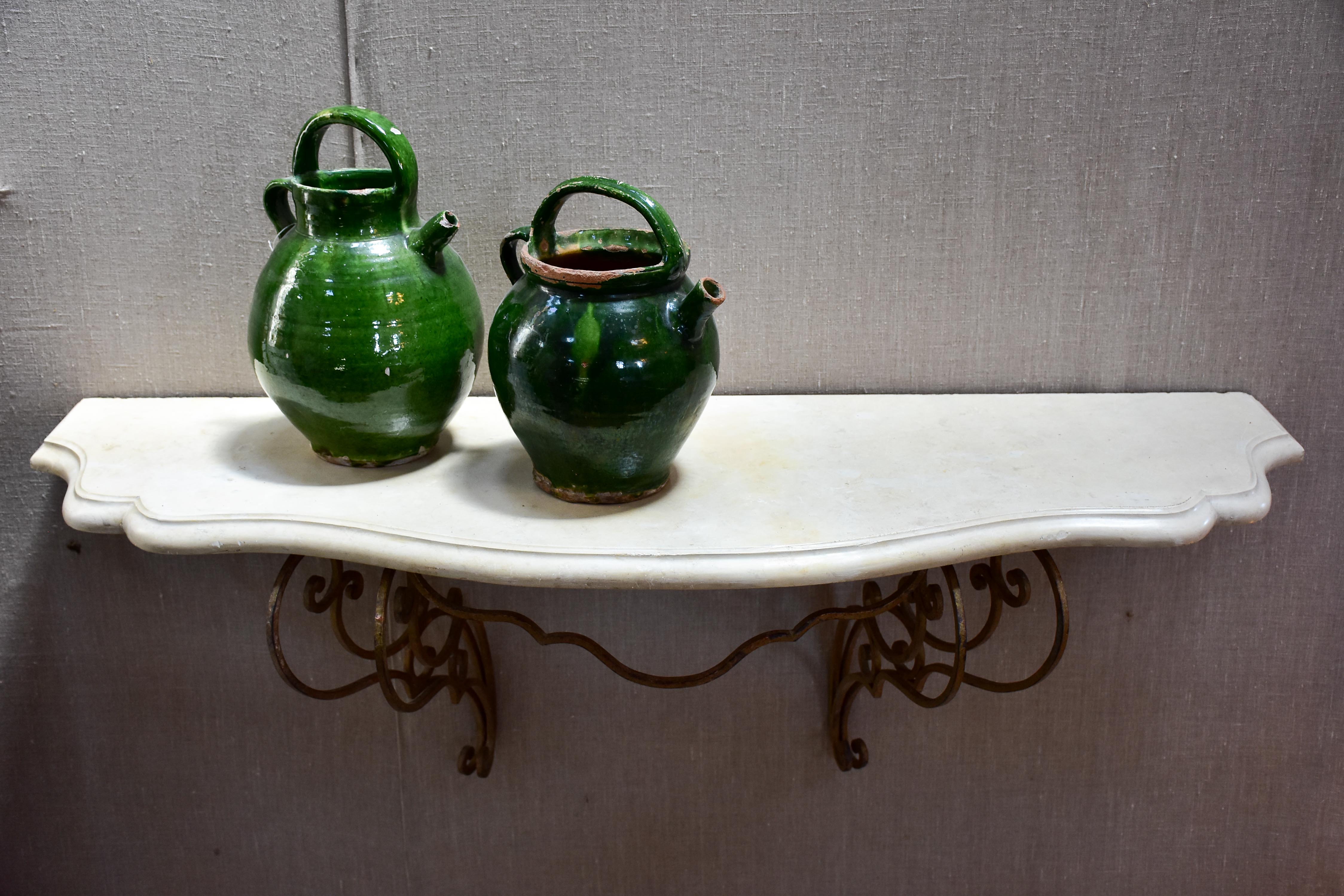 Floating console table with cream marble top and decorative iron base