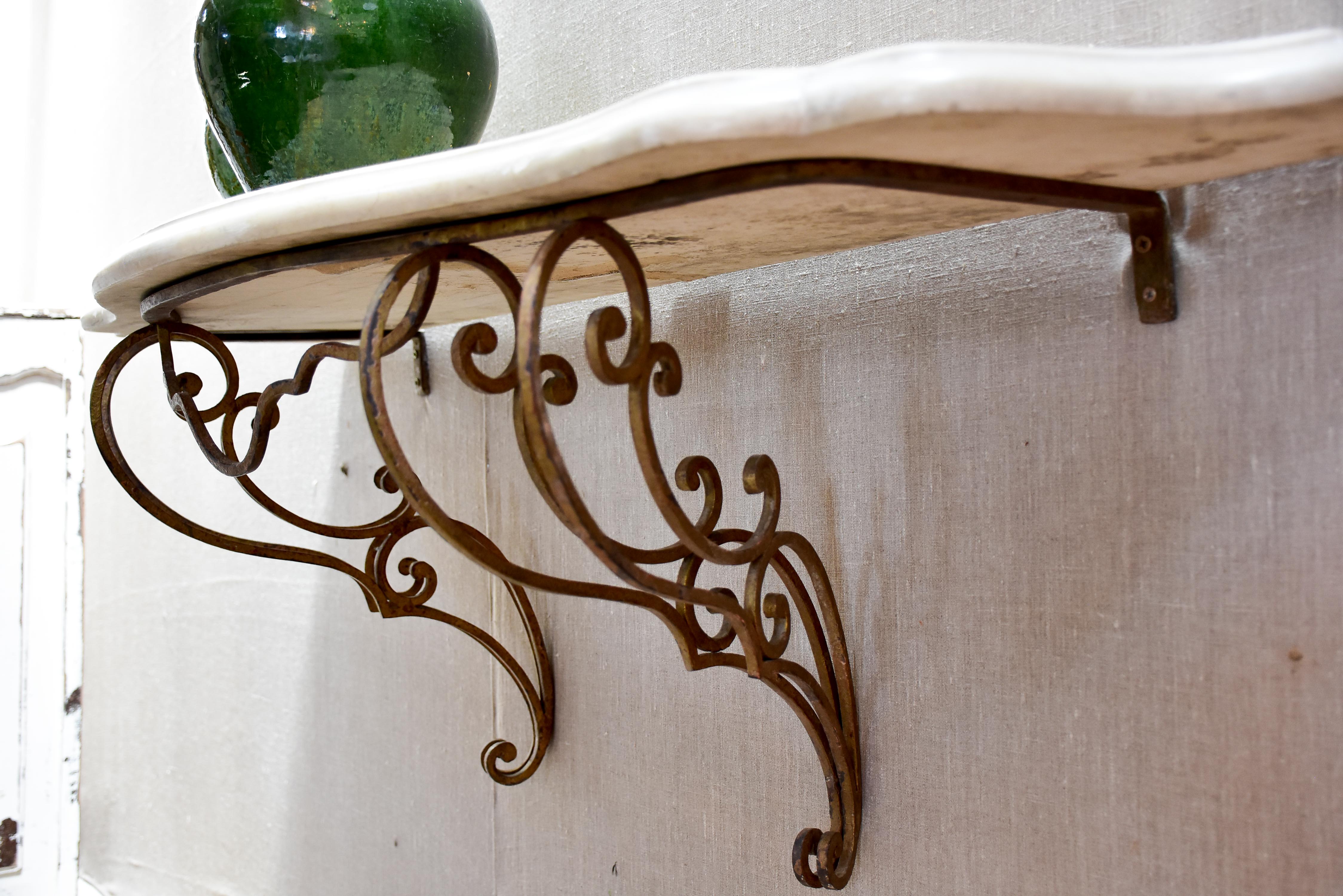 Floating console table with cream marble top and decorative iron base