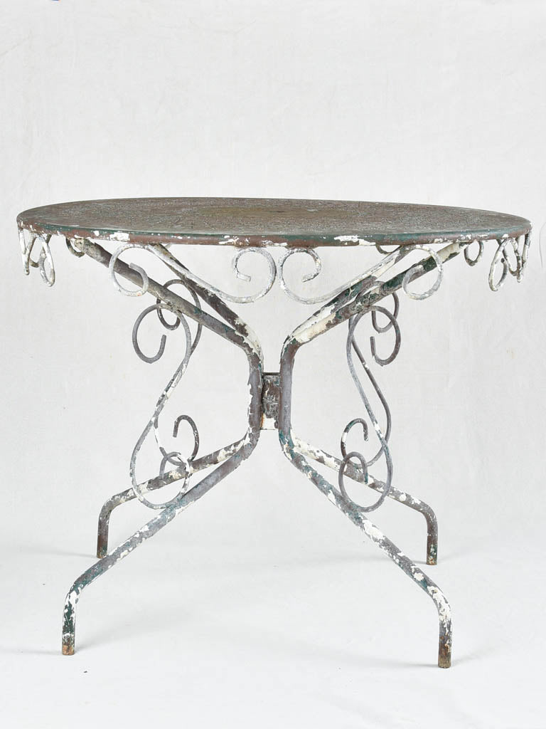 Timeworn painted iron outdoor furniture