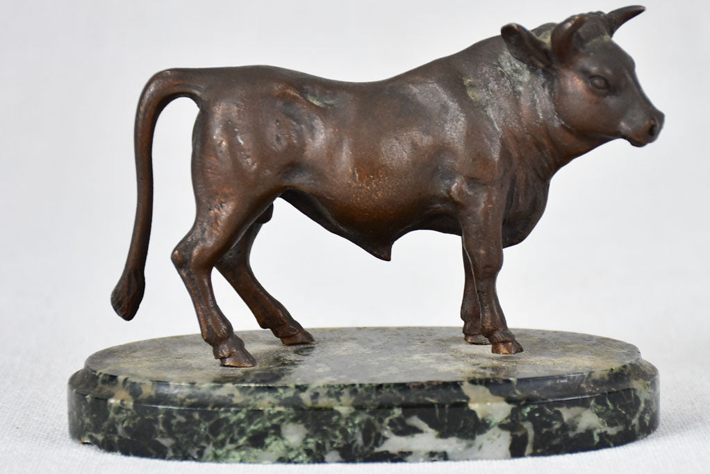 Small bronze statue of a bull on marble base