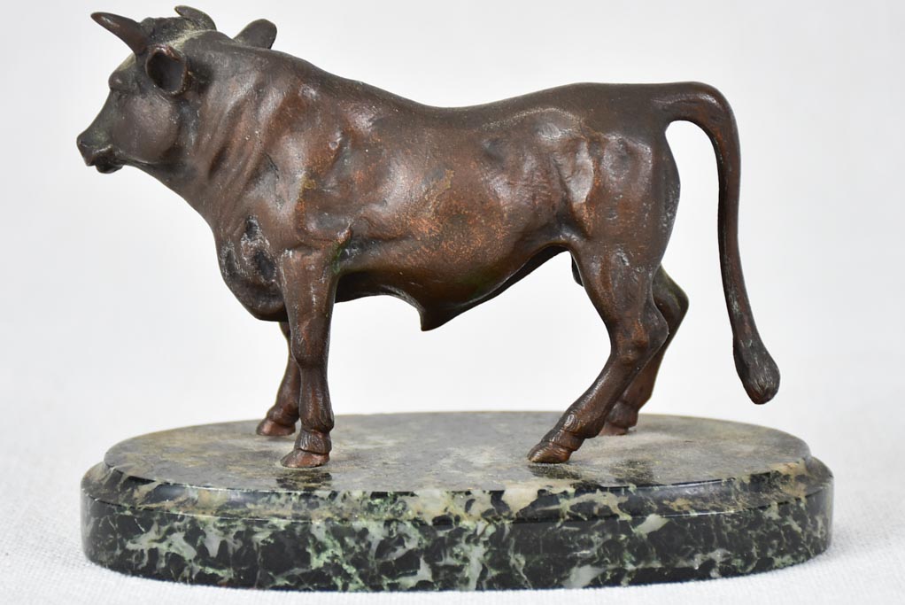 Small bronze statue of a bull on marble base