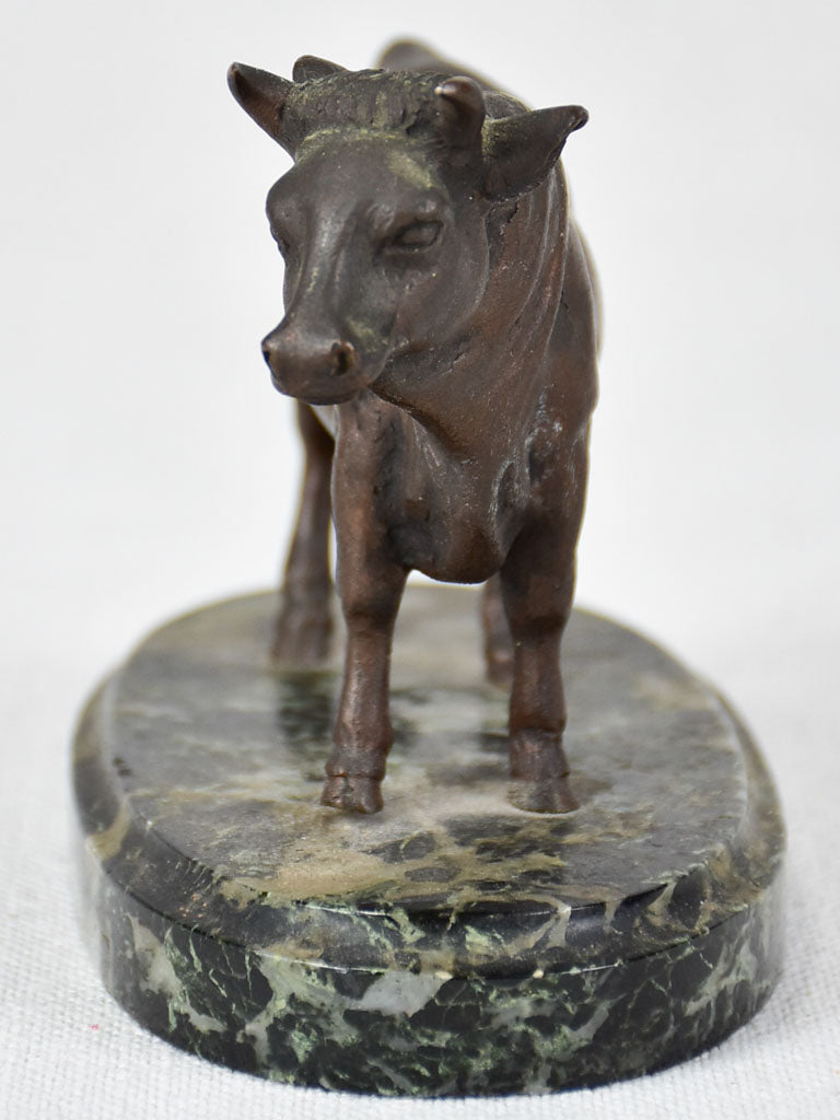 Small bronze statue of a bull on marble base