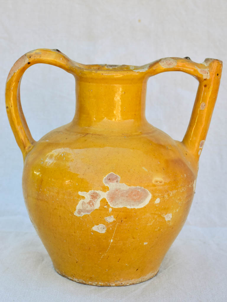 Antique French water pitcher with orange / yellow glaze