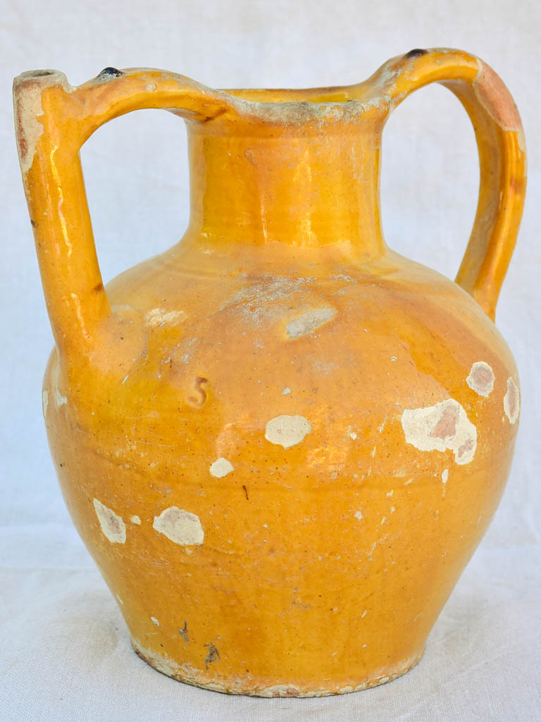 Antique French water pitcher with orange / yellow glaze