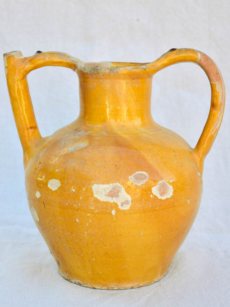 Antique French water pitcher with orange / yellow glaze