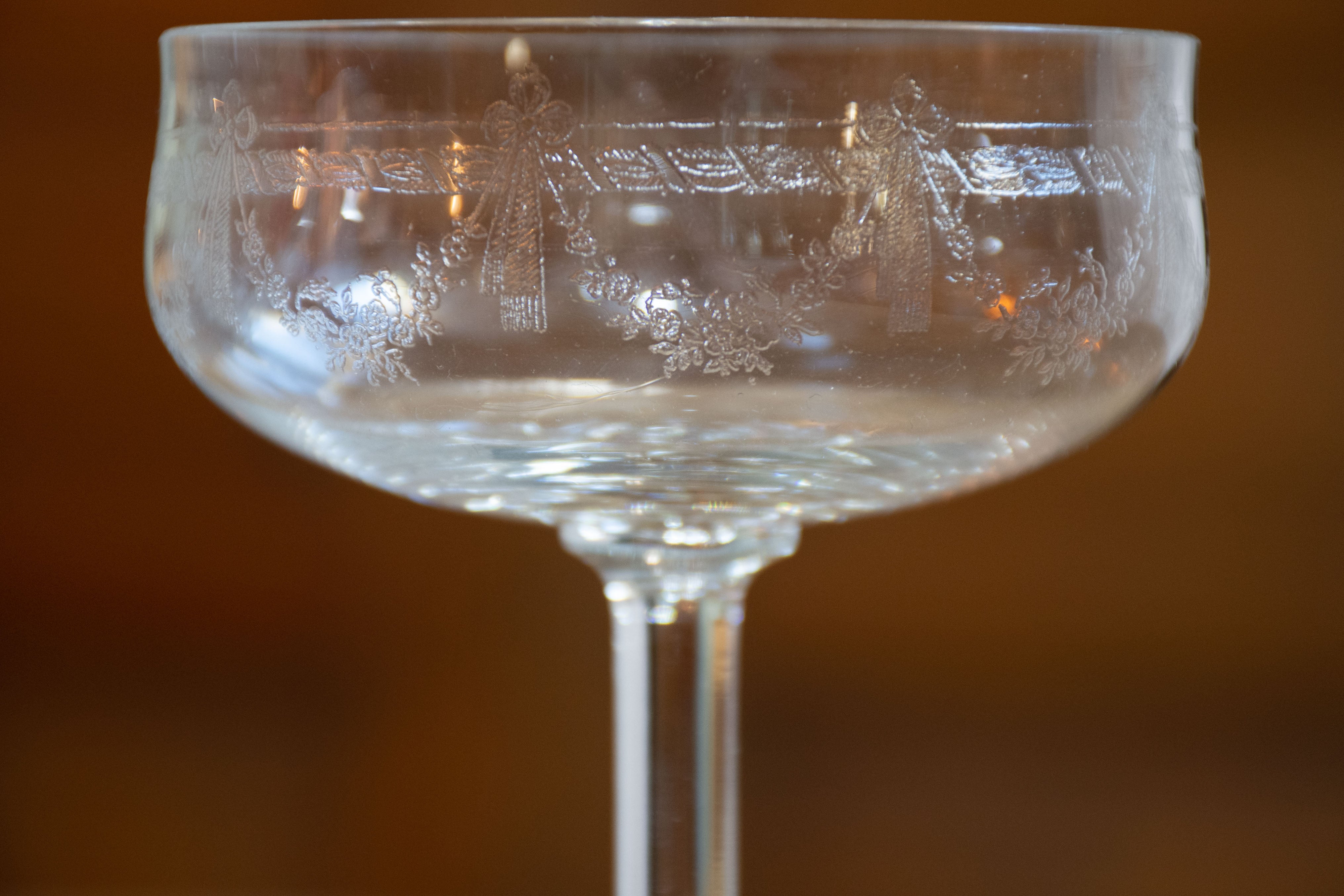 Six antique French champagne cups engraved with bows and garlands