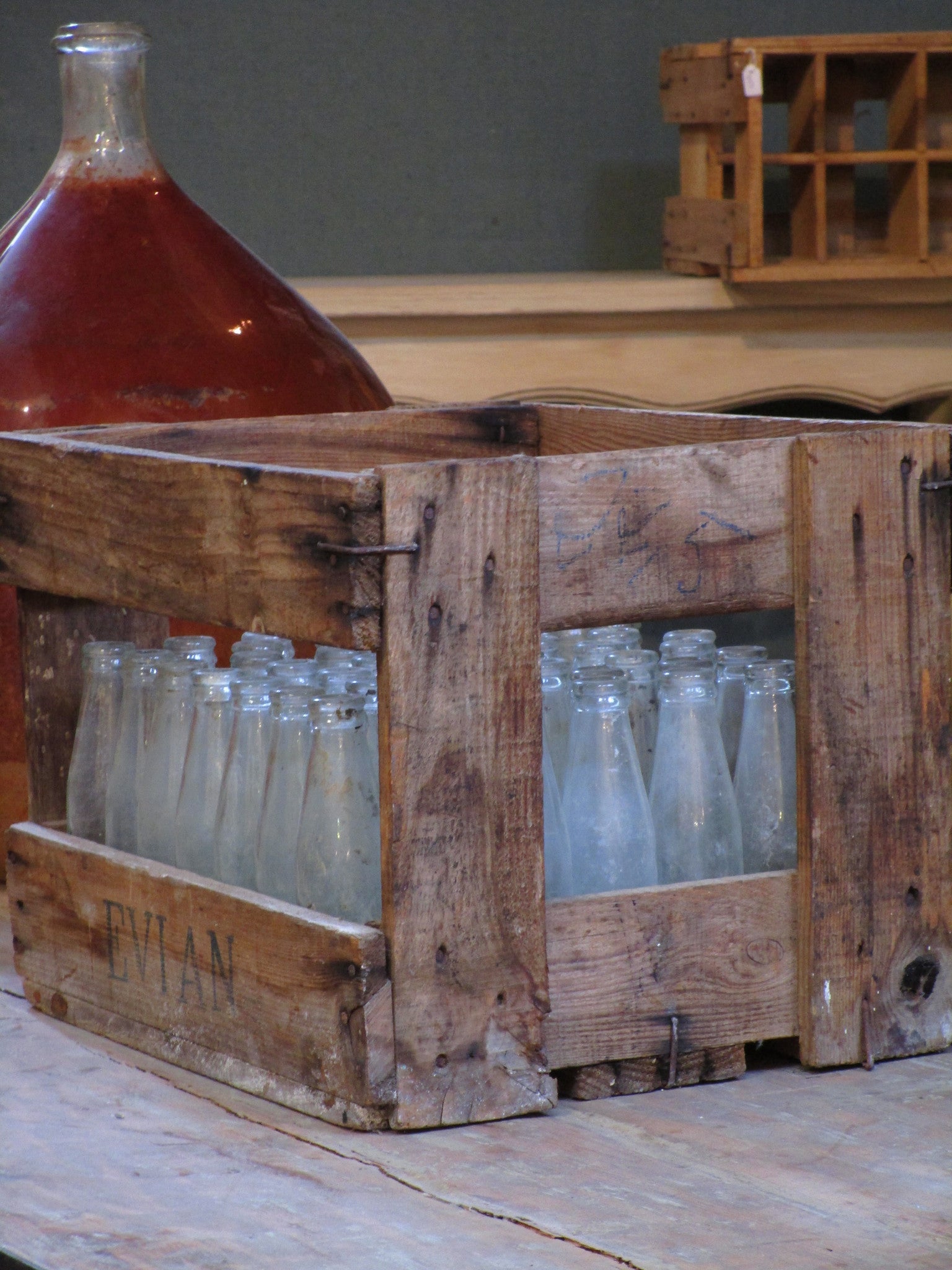 Vintage juice bottles in a rustic wooden box