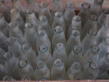 Vintage juice bottles in a rustic wooden box