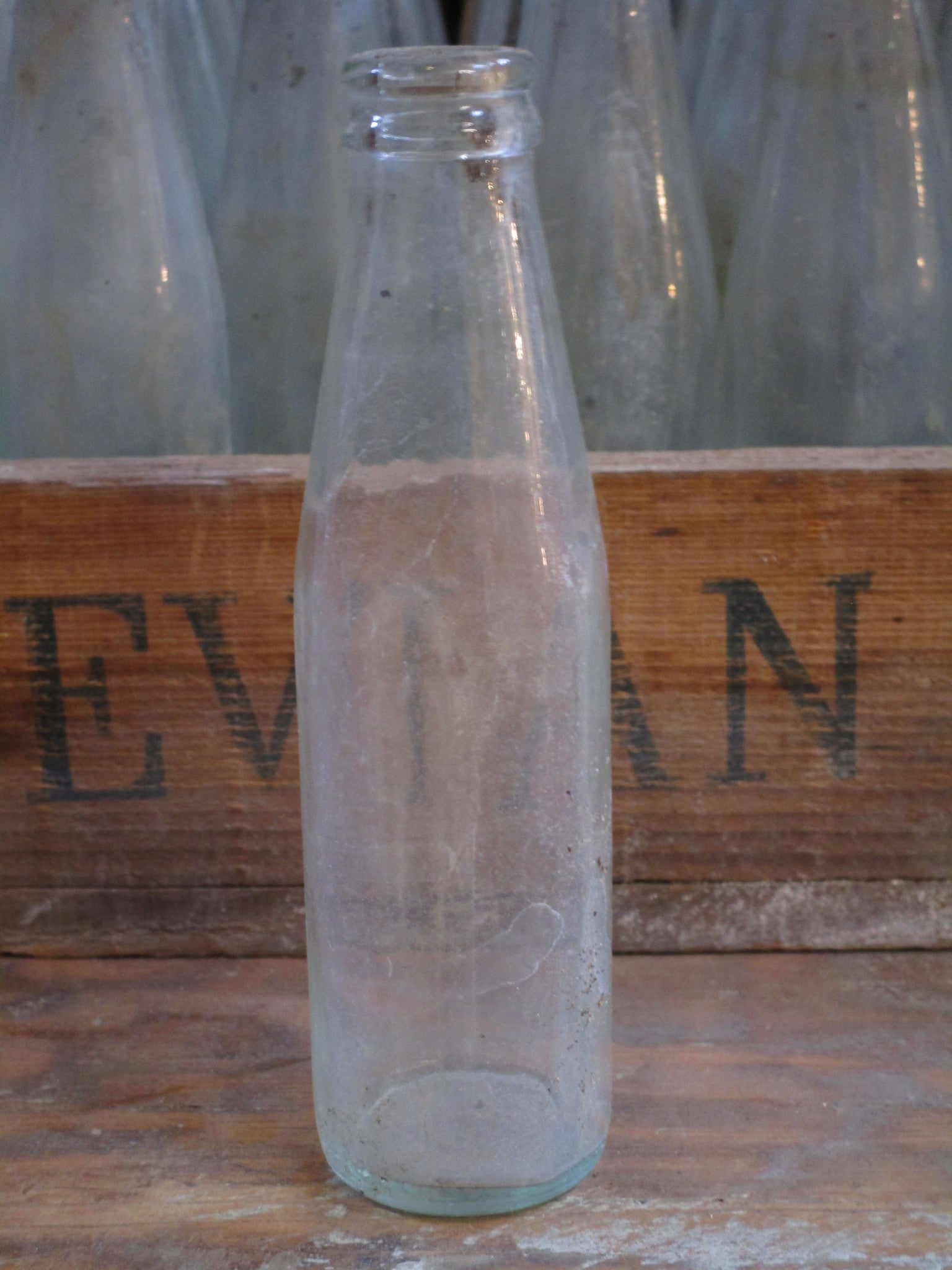 Vintage juice bottles in a rustic wooden box