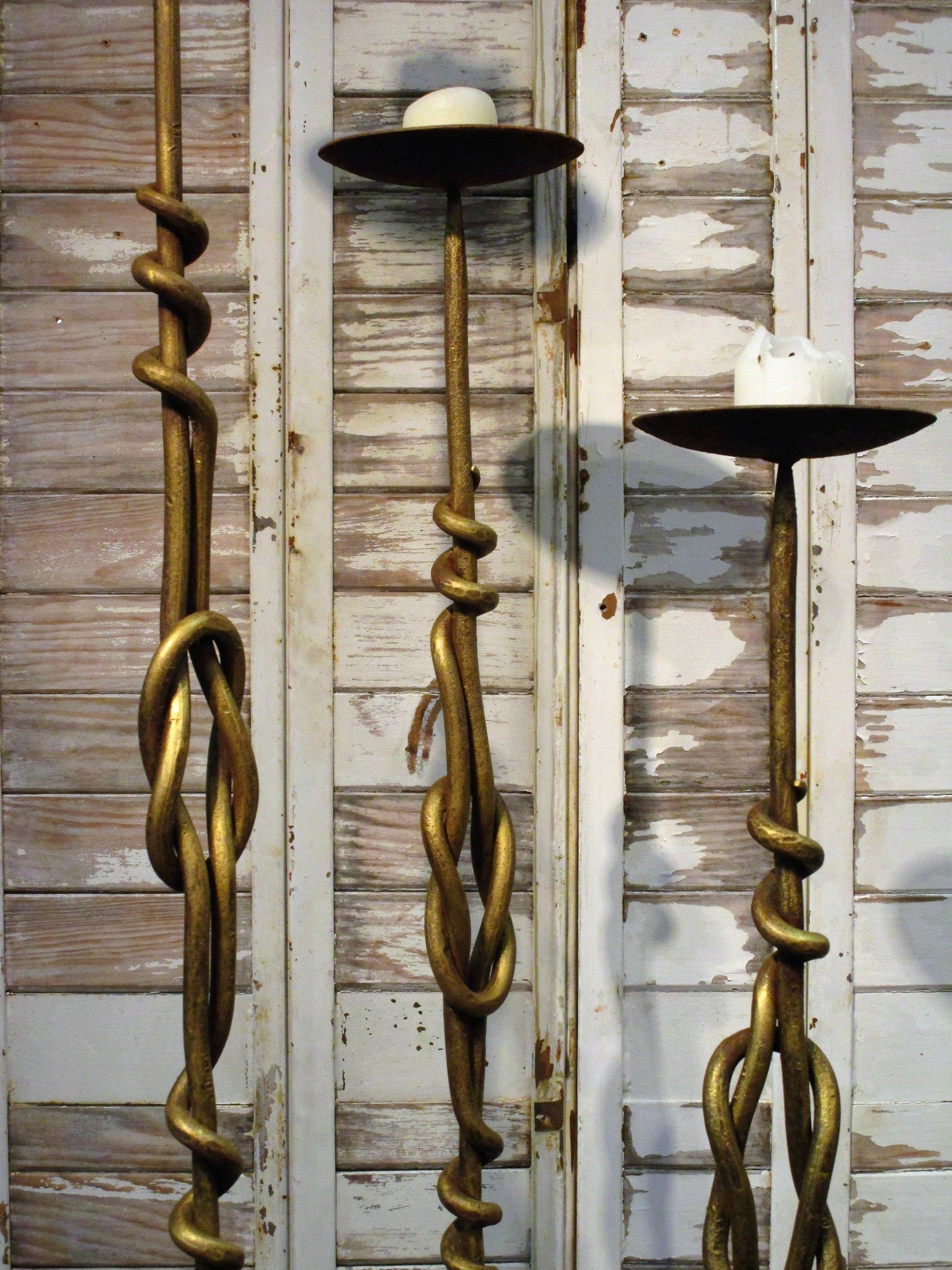 Set of three wrought iron candlesticks