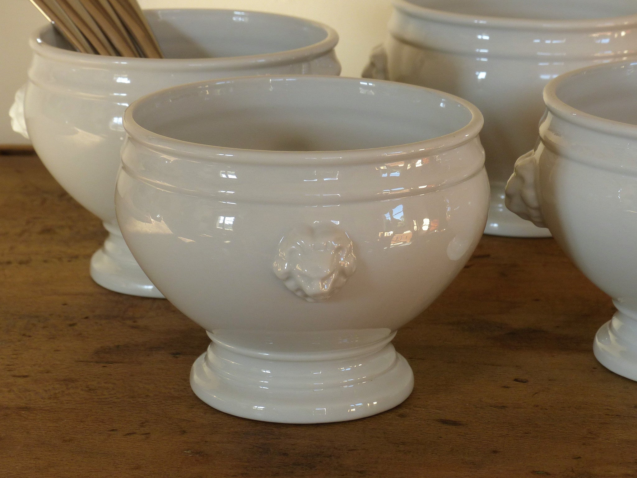 Set of four French lion head soup bowls