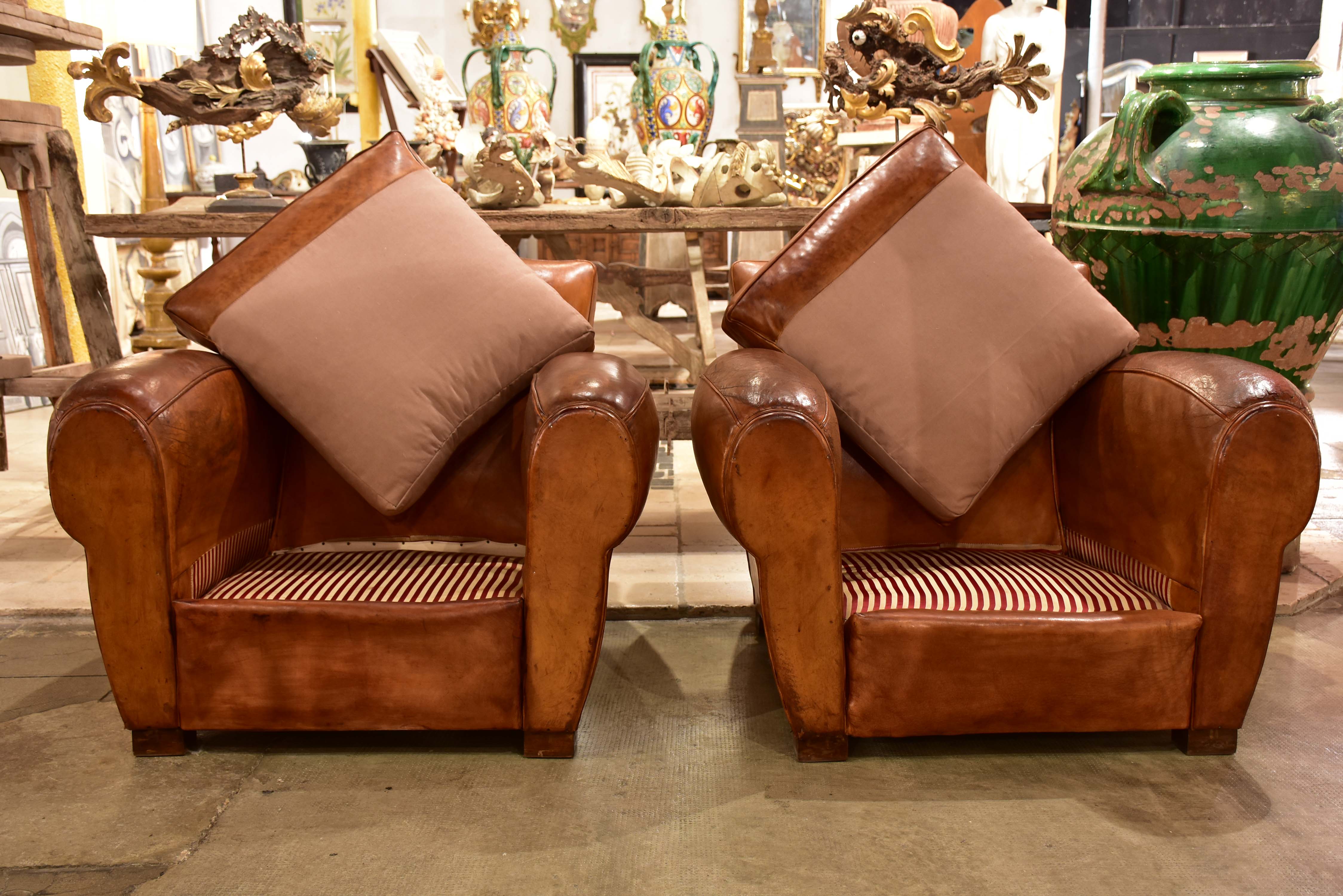 Pair of large vintage French club chairs with mustache back