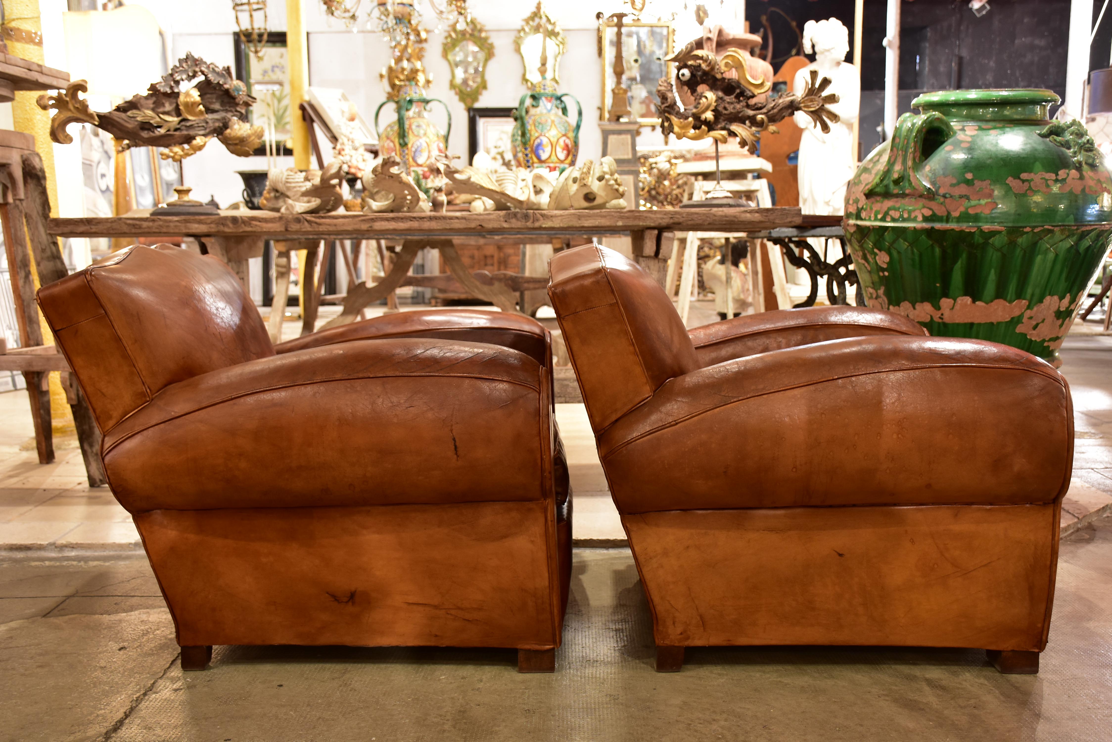 Pair of large vintage French club chairs with mustache back