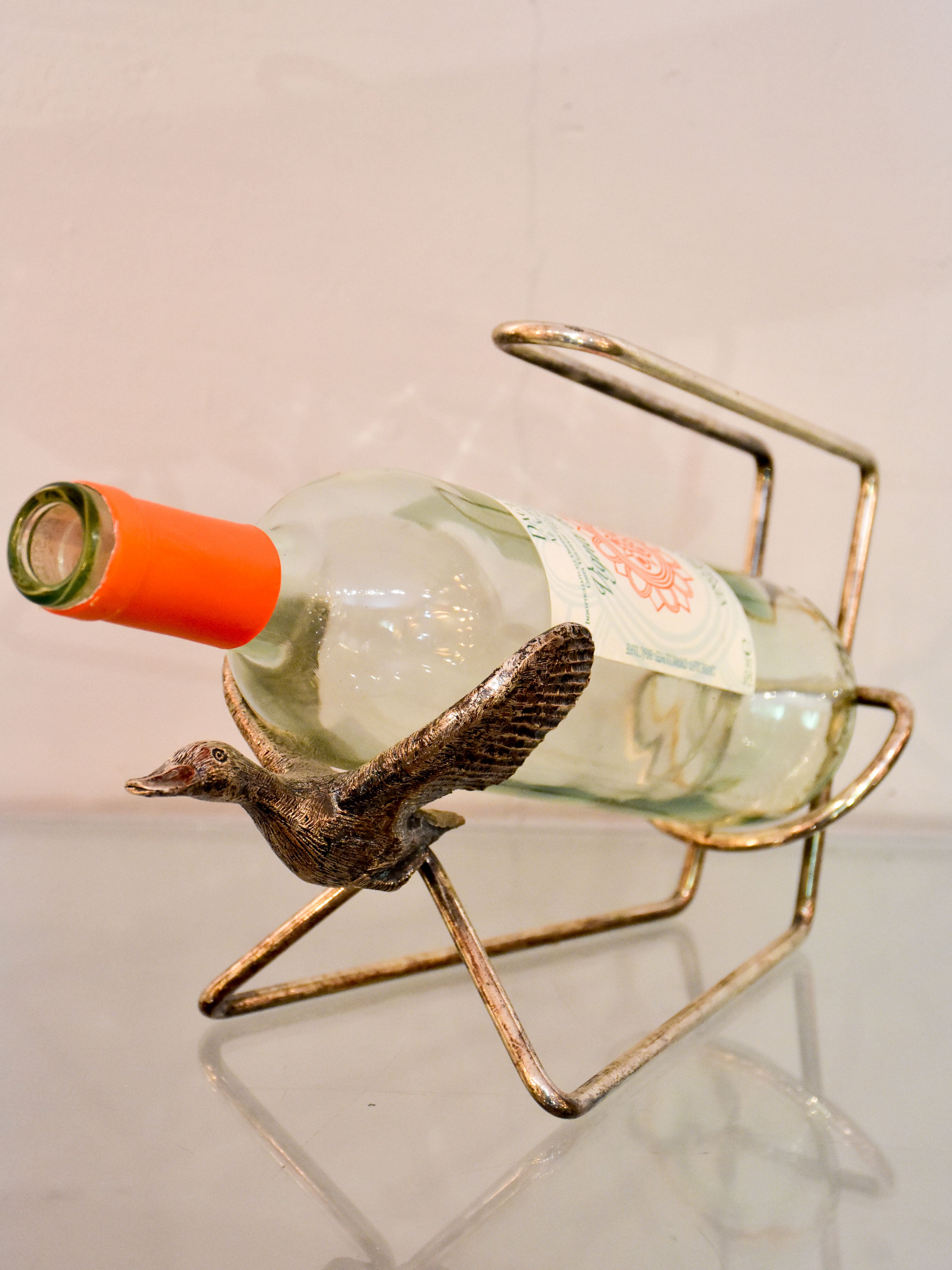 Vintage bottle stand with flying goose cradle