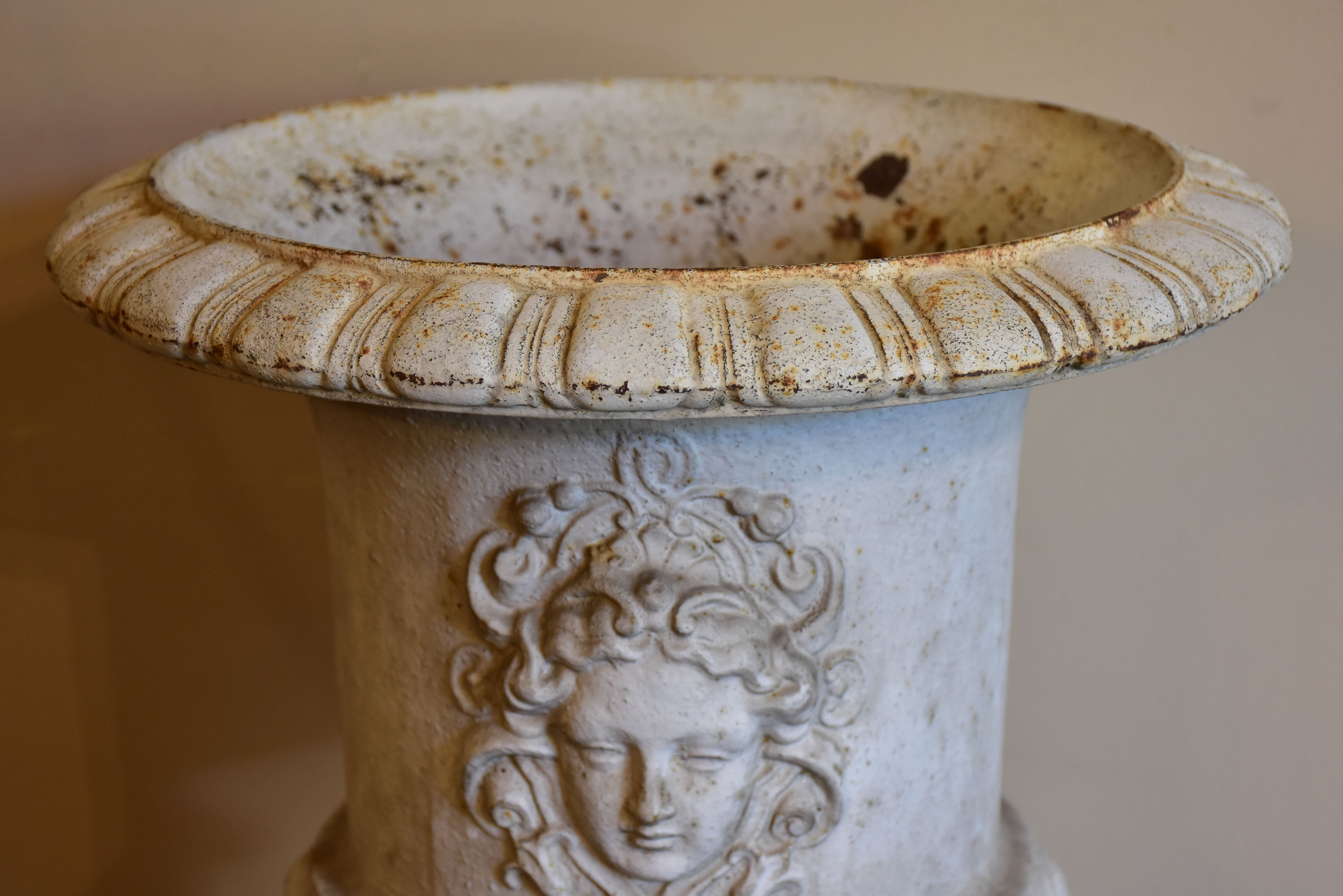 Antique French cast iron garden urn with angel faces